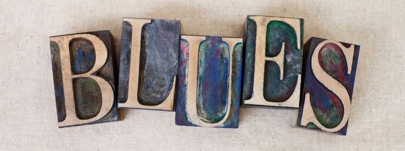 The word "BLUES' spelled out with rubber stamps.