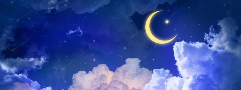 A crescent moon in a starry sky.