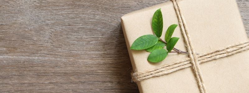 A brown packaged gift with a leaf on top.
