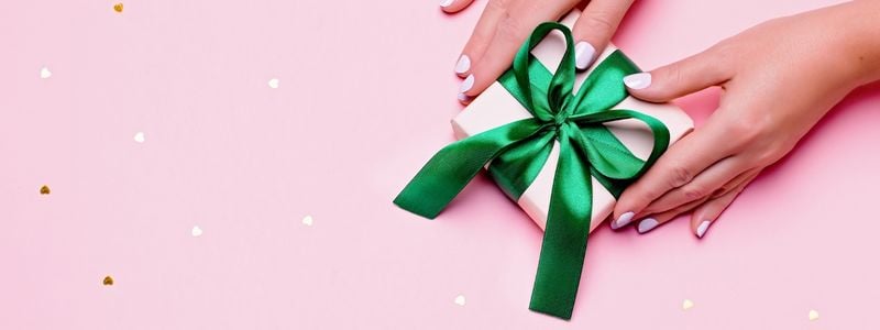 A small pink gift with a green ribbon.