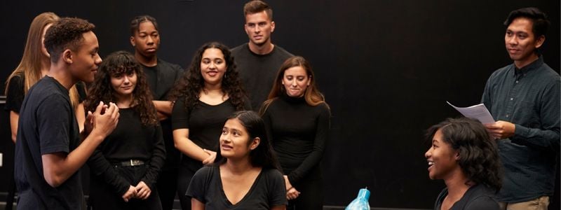 Ten performers rehearsing for a show.